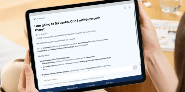 Tablet with screenshot from DKB Bank AI chatbot asking an English Question